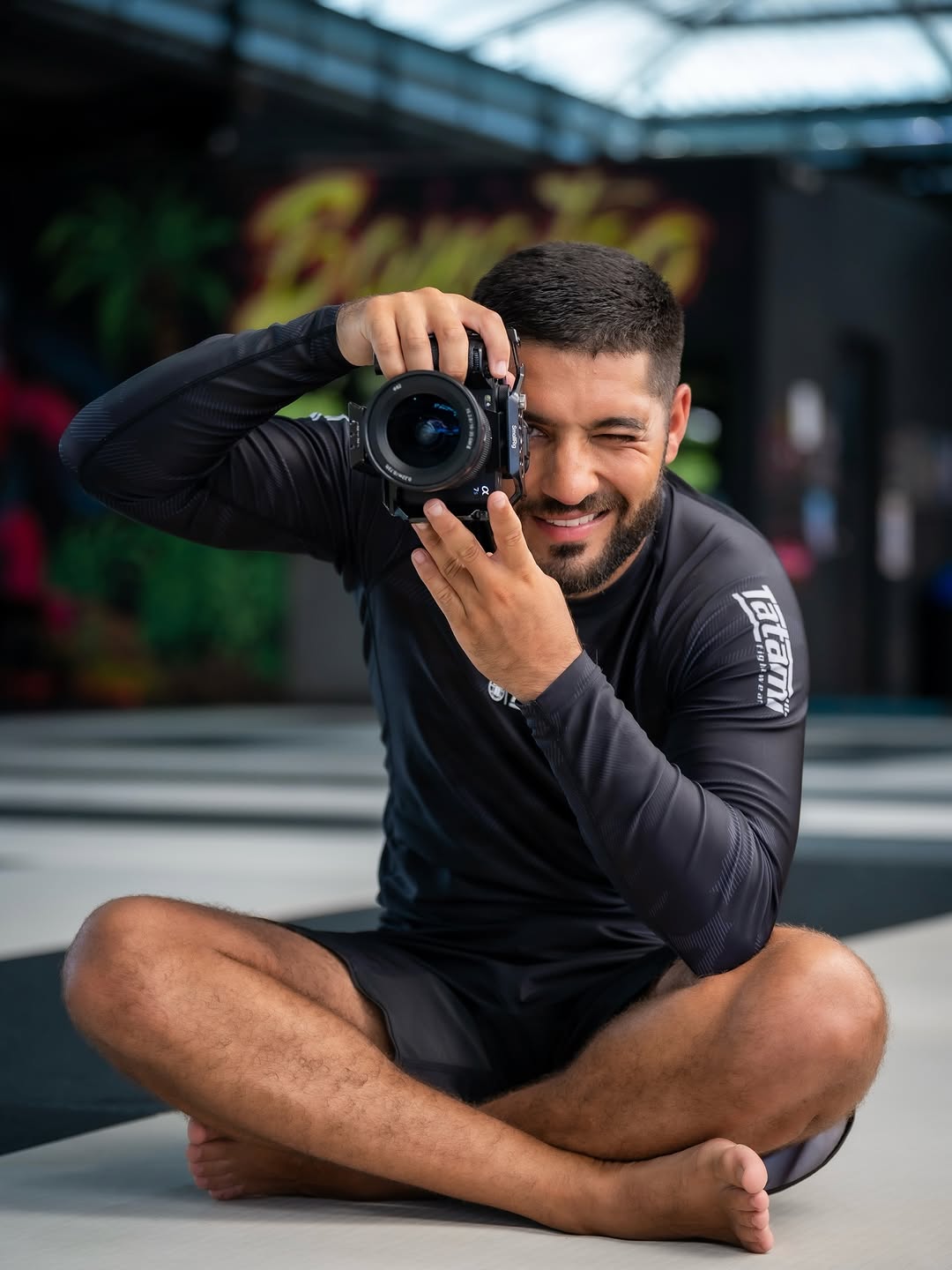 Walid, the Loopshoot photographer, pointing his camera at you from the mats